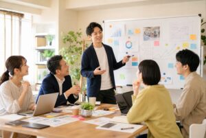 中小企業の社員が会議で意見を出し合いながら当事者意識を高めている様子